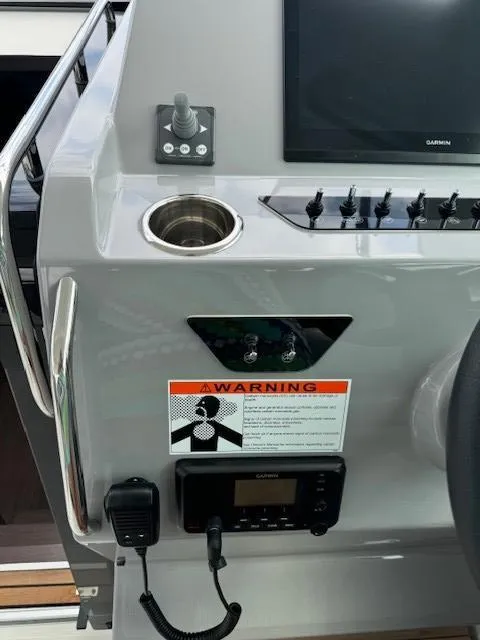 Slide: The Image of Control panel of 2024 Beneteau Gran Turismo 32 with warning label and navigation equipment. - 24