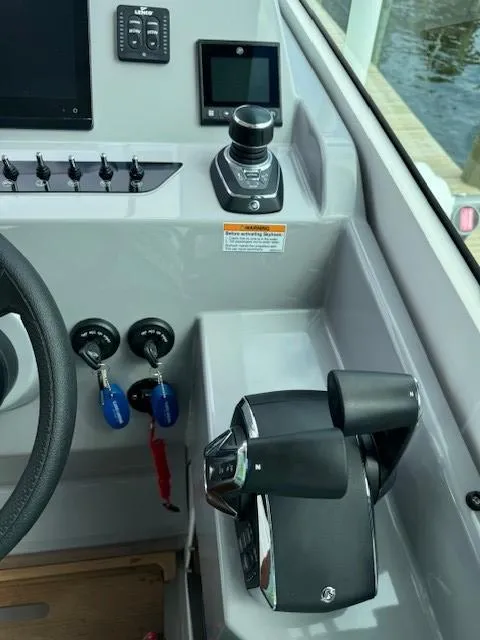 Slide: The Image of Control panel of 2024 Beneteau Gran Turismo 32 with throttle and joystick. - 25
