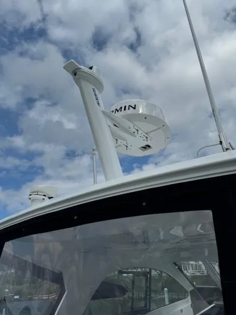 Slide: The Image of 2024 Beneteau Gran Turismo 32 with Garmin radar against a cloudy sky. - 7