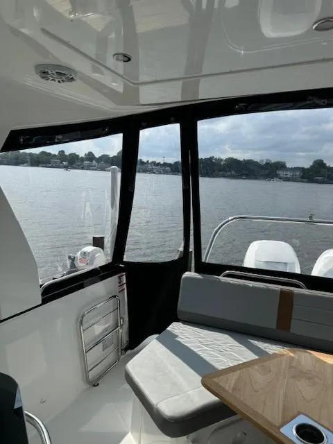 Slide: The Image of 2024 Beneteau Gran Turismo 32 interior with lake view through large windows. - 9
