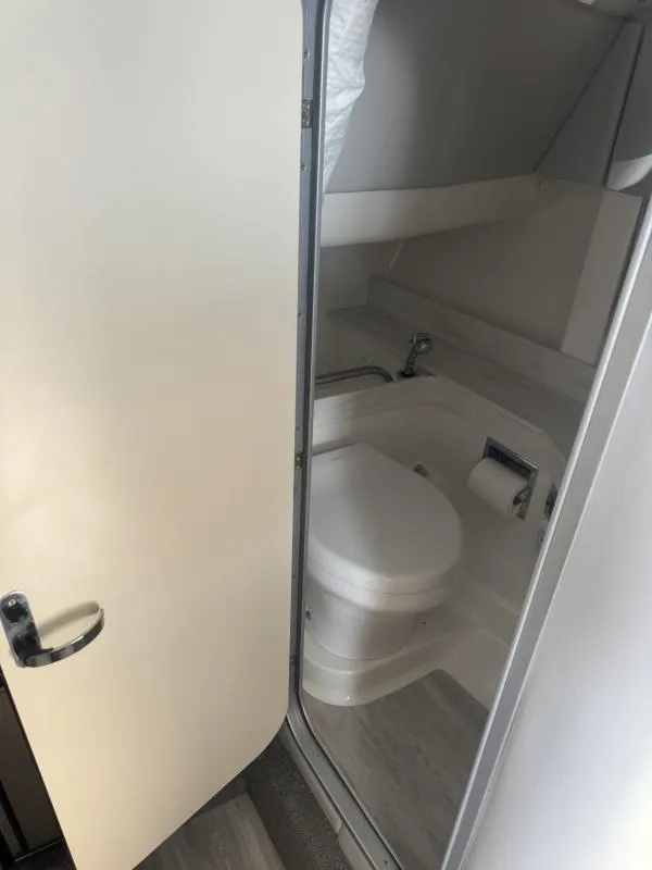 Slide: The Image of 2020 Formula Boats 350 Crossover Bowrider bathroom interior with toilet and sink. - 12