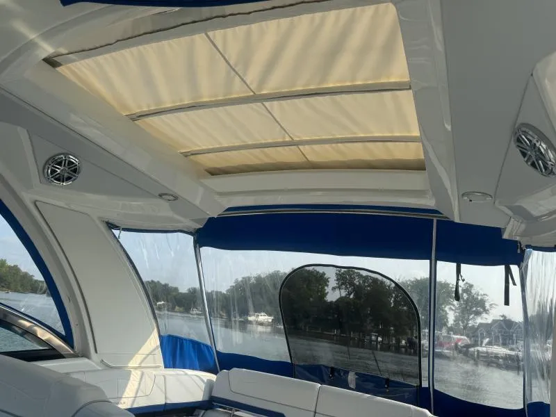 Slide: The Image of Interior view of 2020 Formula Boats 350 Crossover Bowrider with sunroof and blue canopy. - 16