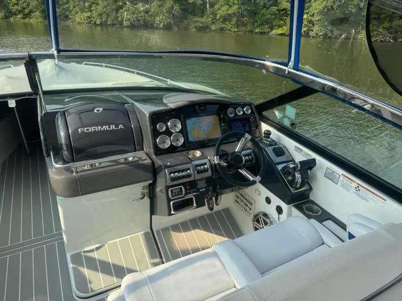 Slide: The Image of 2020 Formula Boats 350 Crossover Bowrider cockpit with modern navigation system and controls. - 22