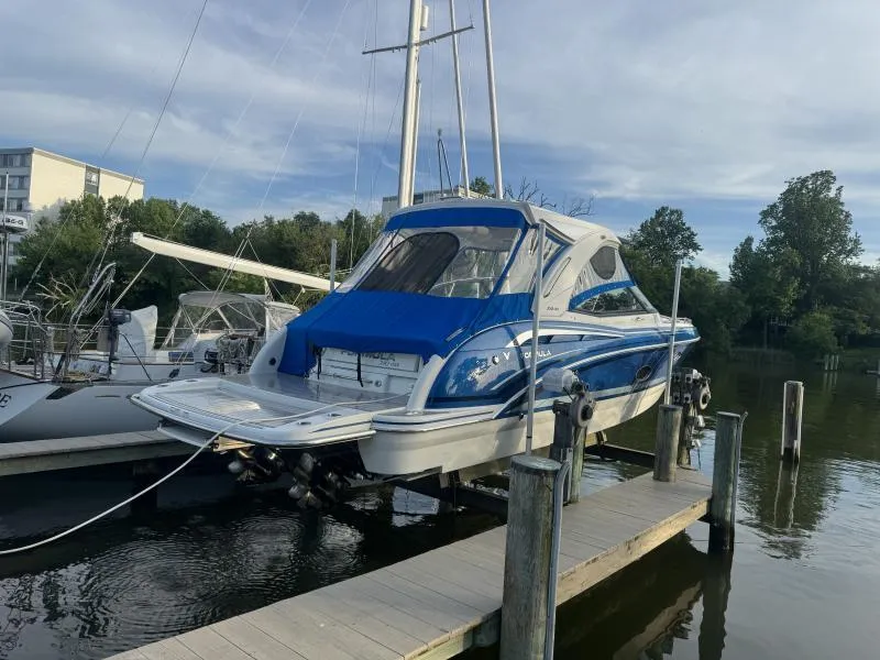Slide: The Image of 2020 Formula Boats 350 Crossover Bowrider docked, featuring sleek blue and white design. - 3