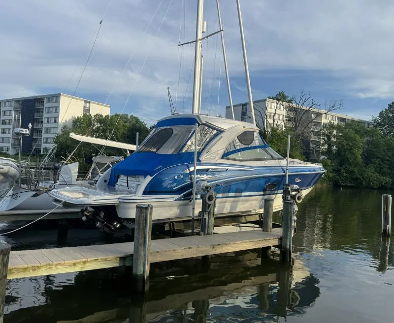 Slide: The Image of 2020 Formula Boats 350 Crossover Bowrider docked at marina, blue and white design. - 4