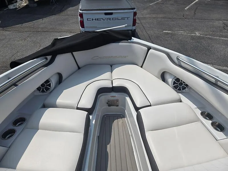Slide: The Image of 2022 Crownline 265 SS boat interior with white seating and cup holders. - 13