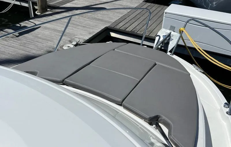 Slide: The Image of 2023 Beneteau Antares 8 boat with cushioned deck at marina. - 11