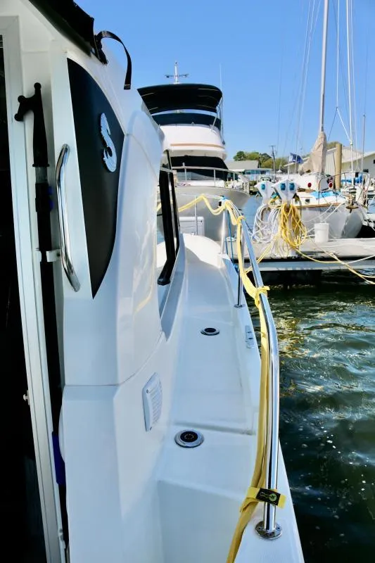 Slide: The Image of 2023 Beneteau Antares 8 docked, showcasing sleek design and modern features. - 13