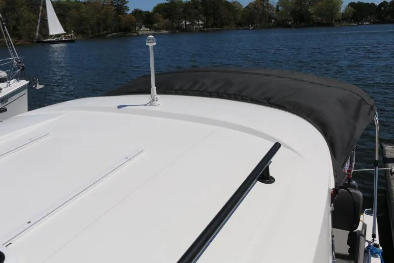 Slide: The Image of 2023 Beneteau Antares 8 boat roof with water and trees in the background. - 14