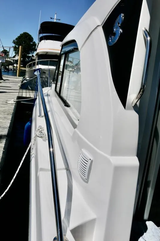 Slide: The Image of 2023 Beneteau Antares 8 docked, showcasing sleek white exterior and modern design. - 15