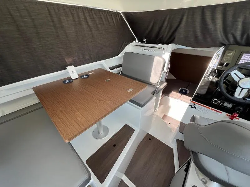 Slide: The Image of Interior of 2023 Beneteau Antares 8, featuring a wooden table and modern seating. - 19