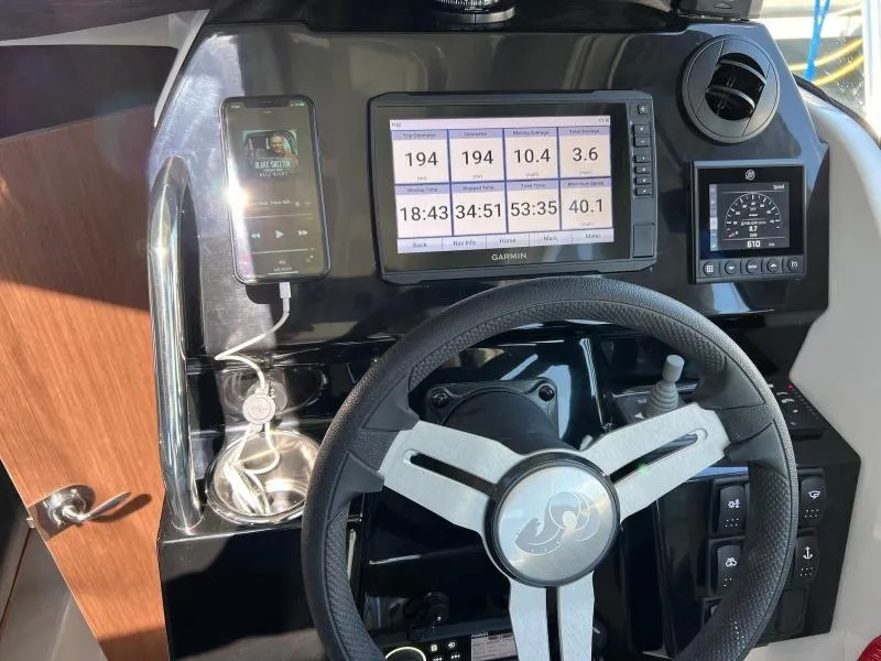 Slide: The Image of Dashboard of 2023 Beneteau Antares 8 with Garmin display and steering wheel. - 21