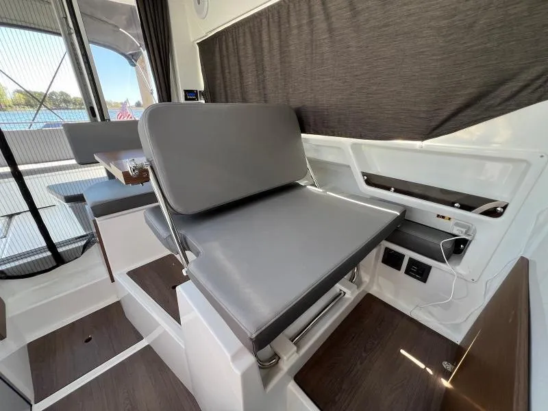 Slide: The Image of Interior of 2023 Beneteau Antares 8, featuring sleek gray seating and modern design elements. - 22