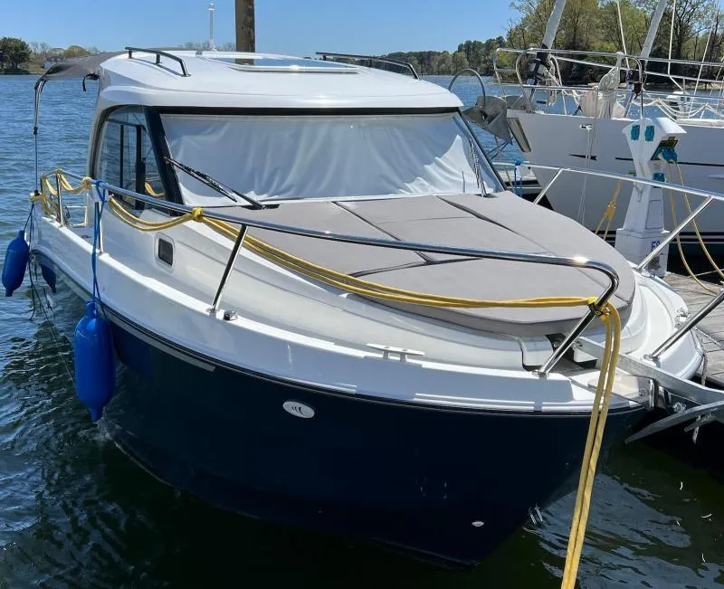 Slide: The Image of 2023 Beneteau Antares 8 boat docked, featuring sleek design and blue hull. - 8