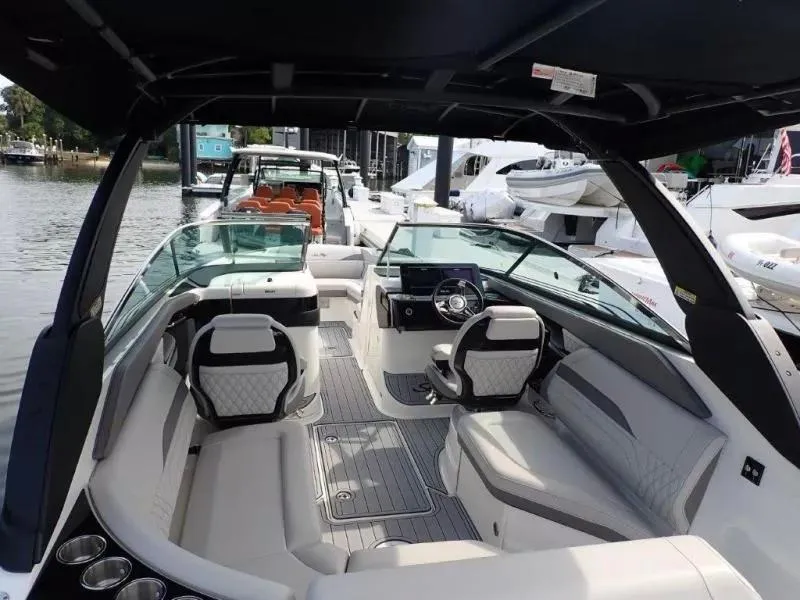 Slide: The Image of 2024 Sea Ray SLX 260 Outboard boat interior with luxurious seating and modern dashboard. - 11