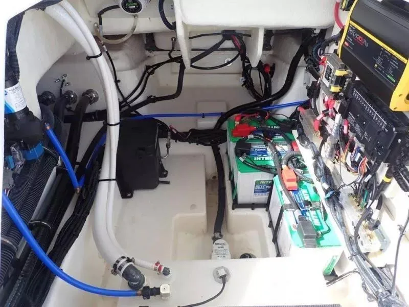 Slide: The Image of 2024 Sea Ray SLX 260 Outboard engine compartment with batteries and wiring. - 14