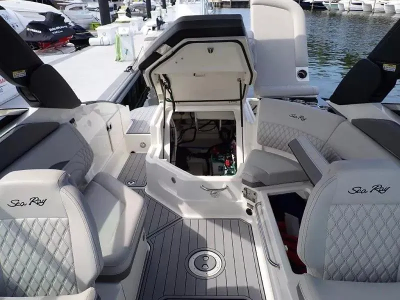 Slide: The Image of 2024 Sea Ray SLX 260 Outboard interior with open engine compartment, docked at marina. - 15