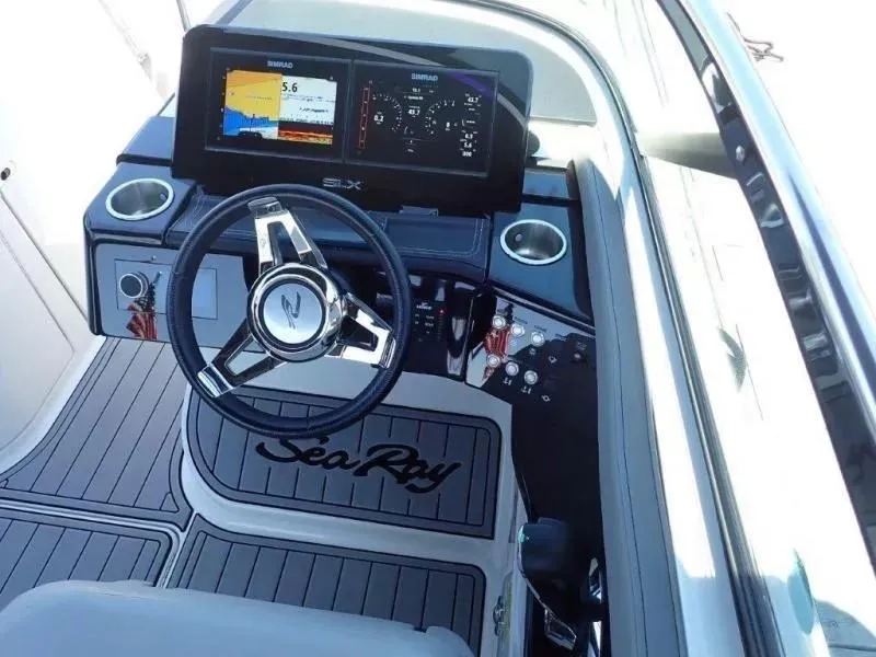 Slide: The Image of 2024 Sea Ray SLX 260 Outboard dashboard with steering wheel and digital displays. - 7