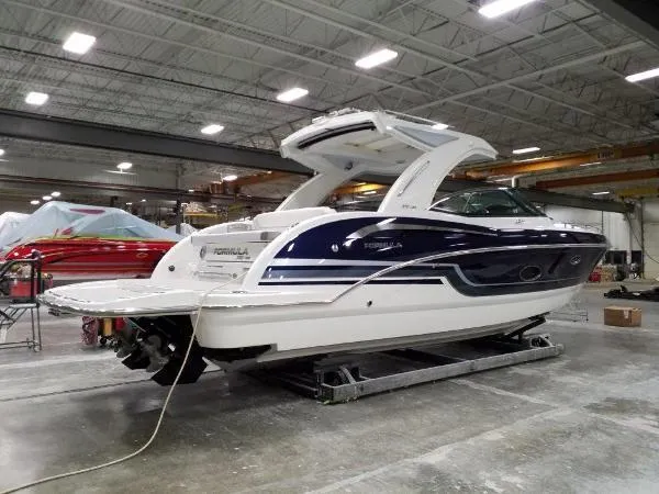 Slide: The Image of 2019 Formula Boats 350 CBR in a showroom, showcasing sleek design and modern features. - 11