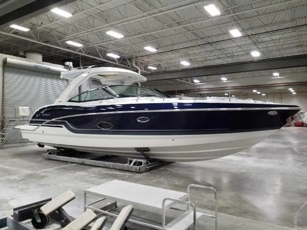 Slide: The Image of 2019 Formula Boats 350 CBR in a spacious indoor showroom. - 13