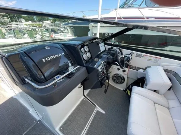 Slide: The Image of 2019 Formula Boats 350 CBR cockpit with modern controls and white seating. - 16