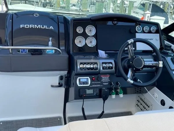 Slide: The Image of 2019 Formula Boats 350 CBR dashboard with steering wheel and control panel. - 17