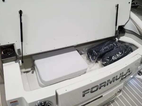 Slide: The Image of 2019 Formula Boats 350 CBR storage compartment with cushions and accessories. - 23