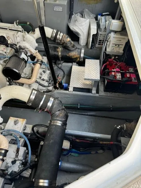 Slide: The Image of Engine compartment of a 2019 Formula Boats 350 CBR, showcasing mechanical components and batteries. - 24