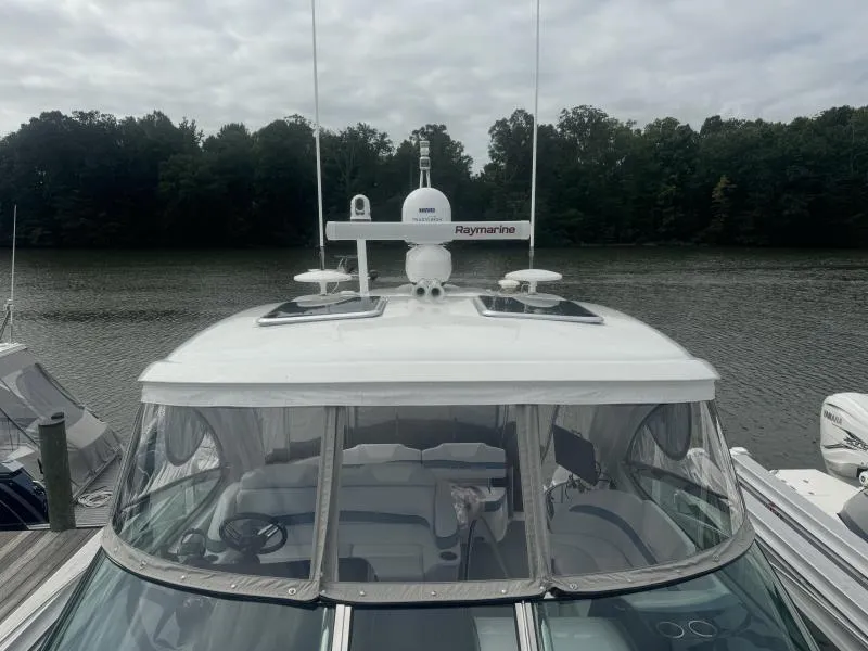 Slide: The Image of 2023 Formula Boats 40 PC docked, featuring Raymarine equipment, against a serene lake backdrop. - 11