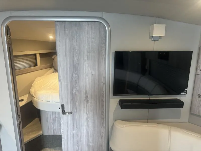 Slide: The Image of Interior of 2023 Formula Boats 40 PC with TV, bed, and modern decor. - 16