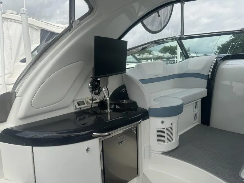 Slide: The Image of 2023 Formula Boats 40 PC interior with seating, TV, and kitchenette. - 7