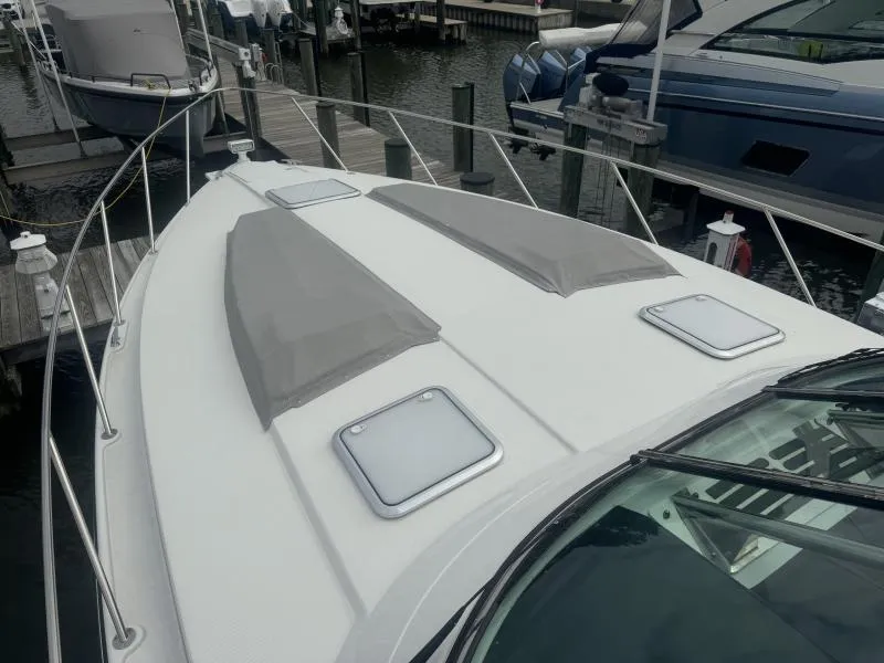 Slide: The Image of 2023 Formula Boats 40 PC docked, showcasing sleek deck design and hatches. - 9