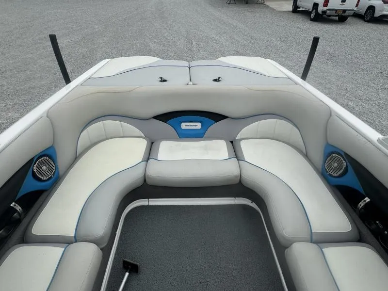 Slide: The Image of 2013 Malibu Wakesetter 23 LSV boat interior with white and blue seating. - 10