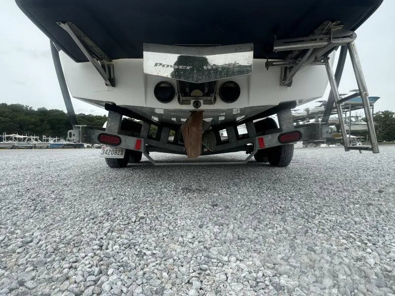 Slide: The Image of 2013 Malibu Wakesetter 23 LSV on trailer, rear view, parked on gravel. - 13