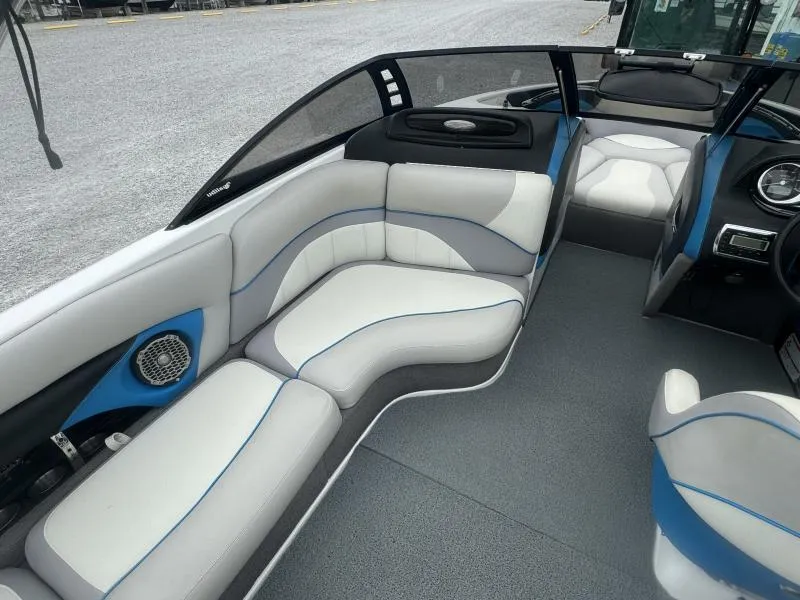 Slide: The Image of 2013 Malibu Wakesetter 23 LSV interior with white and blue seating, modern design. - 16