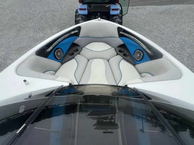 Slide: The Image of 2013 Malibu Wakesetter 23 LSV boat interior with white and blue seating. - 19