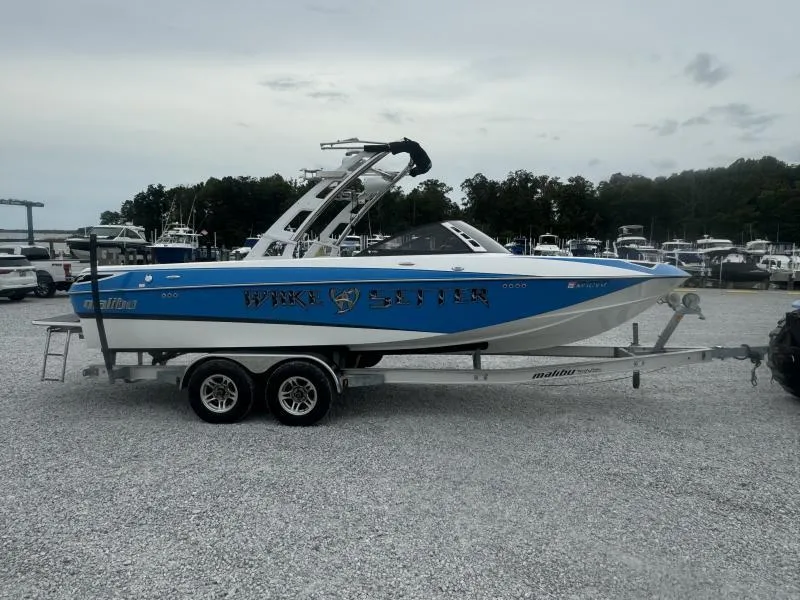 Slide: The Image of 2013 Malibu Wakesetter 23 LSV boat on trailer in marina setting. - 4