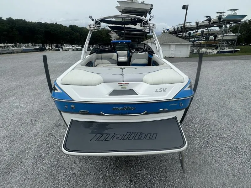 Slide: The Image of 2013 Malibu Wakesetter 23 LSV boat, blue and white, rear view in a marina. - 5