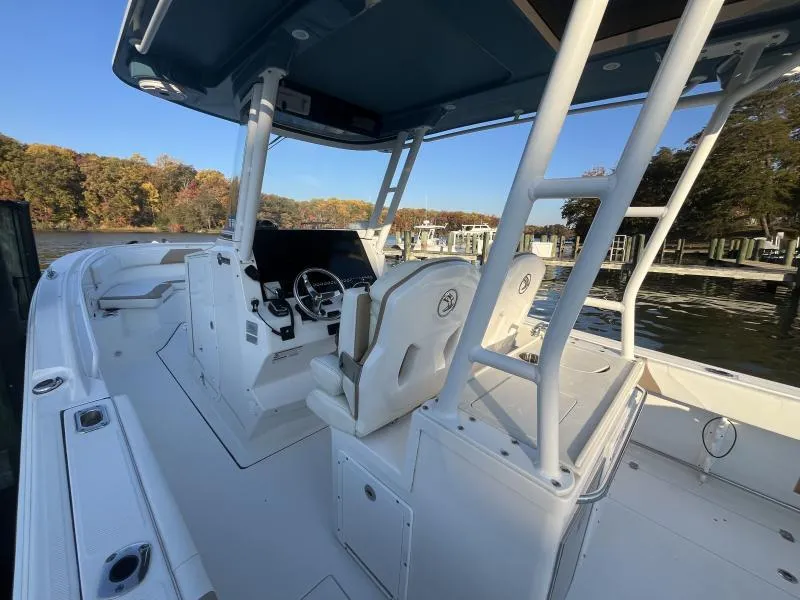 Slide: The Image of 2020 Edgewater 280 Center Console boat interior with helm, seats, and water view. - 10