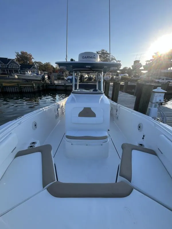Slide: The Image of 2020 Edgewater 280 Center Console boat docked at marina, sunny day. - 12