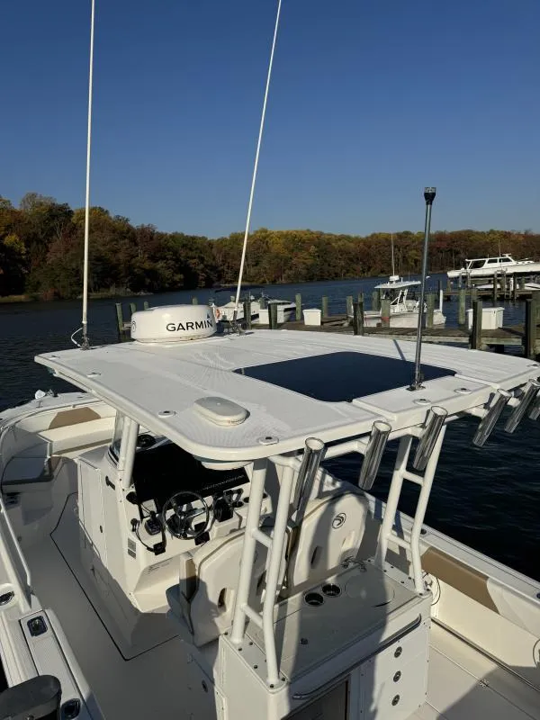 Slide: The Image of 2020 Edgewater 280 Center Console boat docked, featuring Garmin equipment and spacious deck. - 4