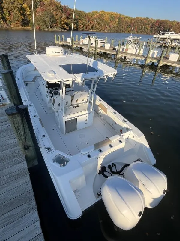 Slide: The Image of 2020 Edgewater 280 Center Console boat docked by a scenic lake. - 9
