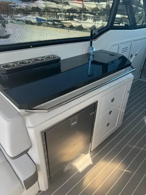 Slide: The Image of 2020 Formula Boats 380 SSC interior with sleek kitchenette and modern amenities. - 14