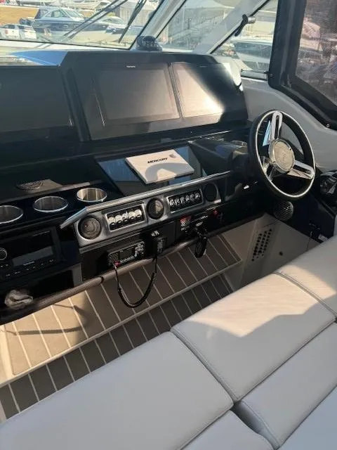 Slide: The Image of 2020 Formula Boats 380 SSC cockpit with modern controls and steering wheel. - 17