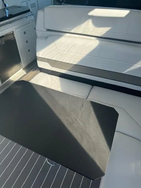 Slide: The Image of 2020 Formula Boats 380 SSC interior with white seating and black table. - 22