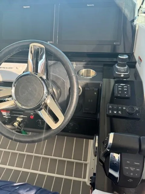 Slide: The Image of 2020 Formula Boats 380 SSC helm with steering wheel and control panel. - 23