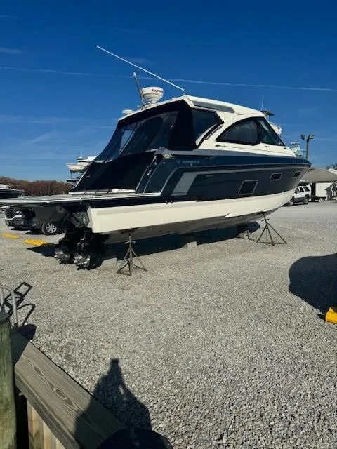 Slide: The Image of 2020 Formula Boats 380 SSC on gravel lot, side view, under clear blue sky. - 5