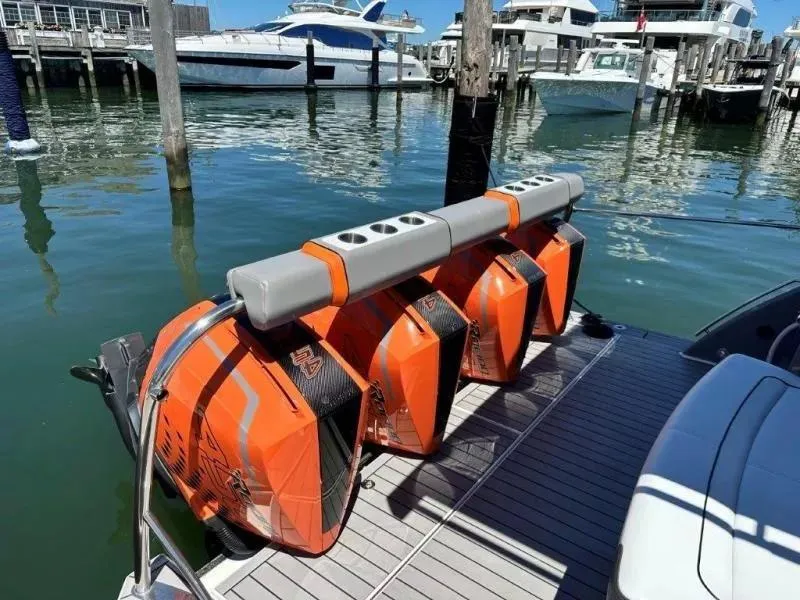 Slide: The Image of Four orange outboard motors on a 2022 Formula 430 Super Sport Crossover at a marina. - 13
