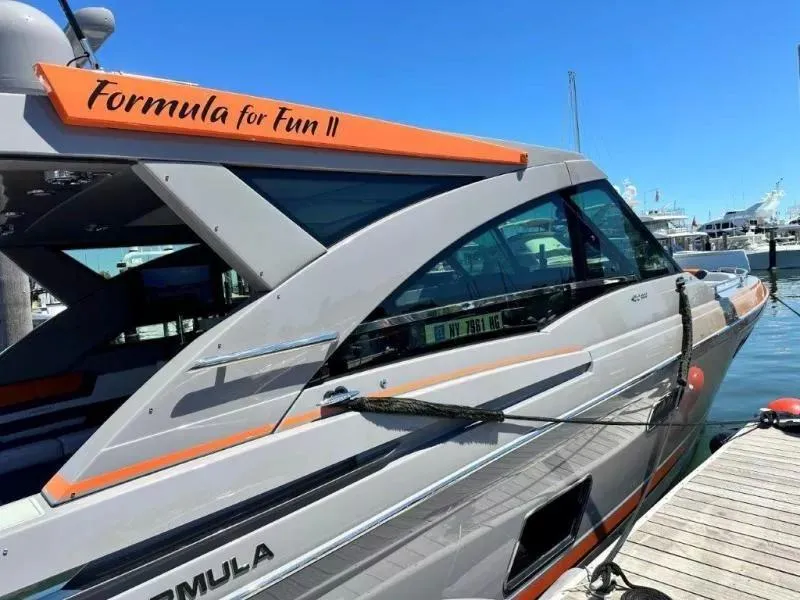 Slide: The Image of 2022 Formula 430 Super Sport Crossover yacht docked, featuring sleek design and vibrant accents. - 15