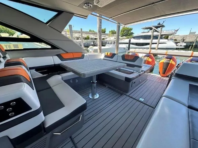 Slide: The Image of Luxurious 2022 Formula 430 Super Sport Crossover yacht interior with sleek seating and table. - 16